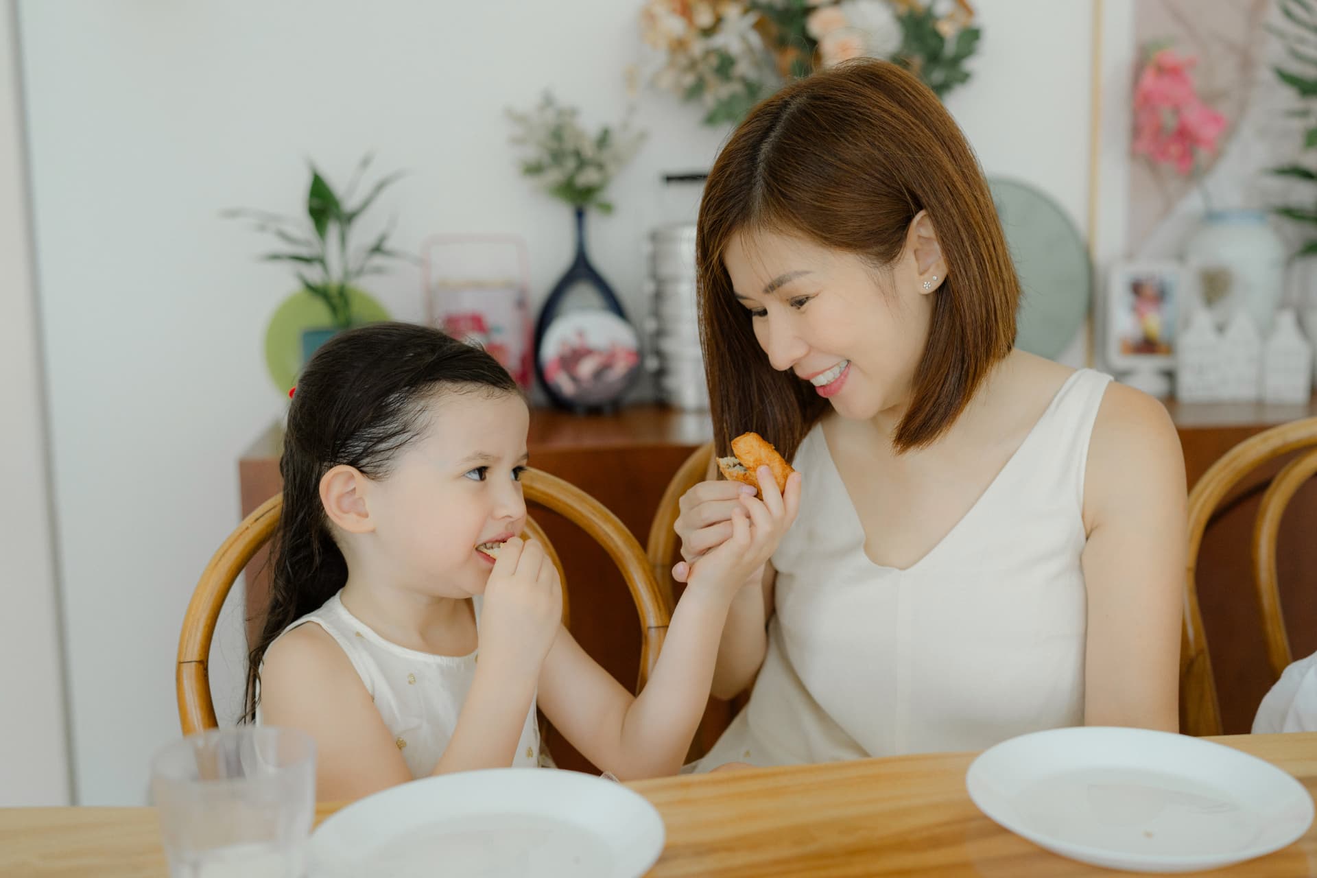 Debbie and her daughter Zoe sharing a snack at the dinner table